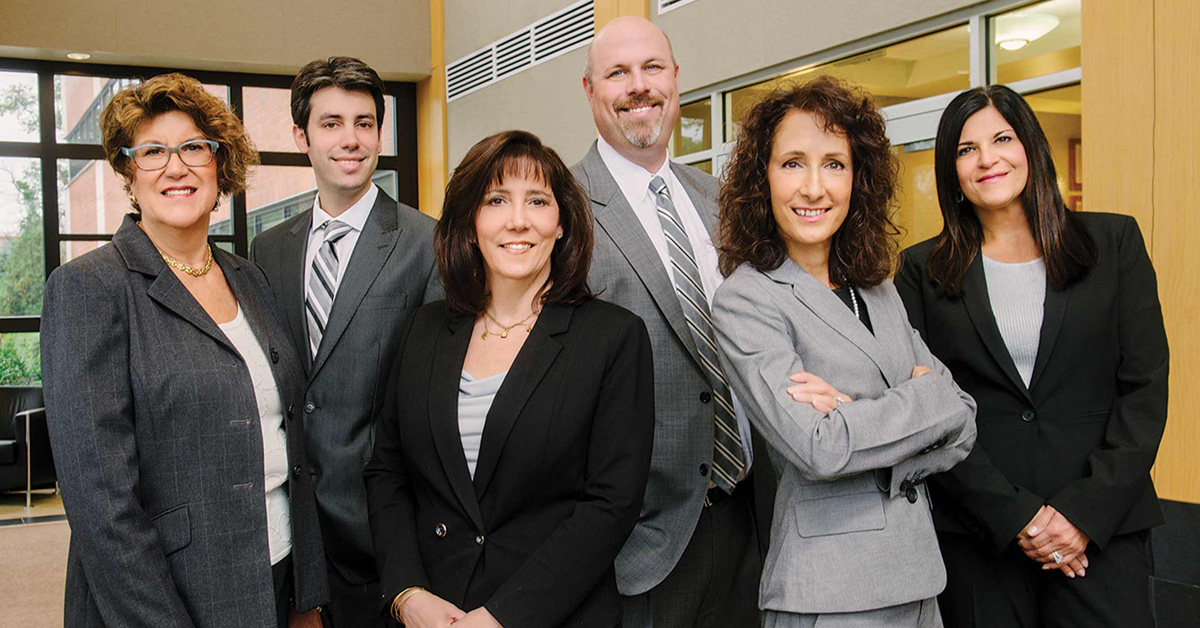 A group of business people posing for a photo.