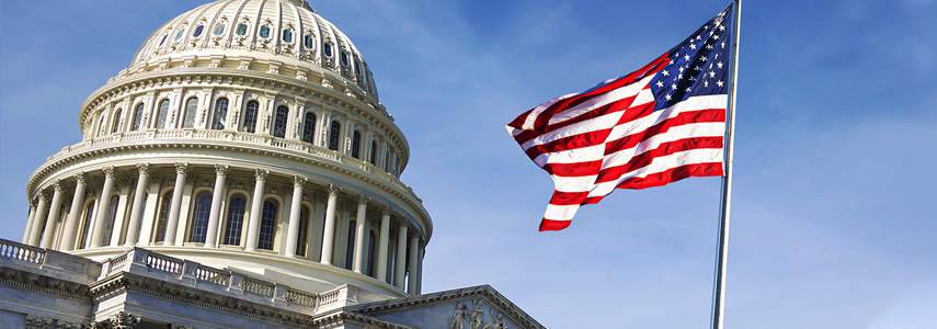 An american flag is flying in front of the capitol building.