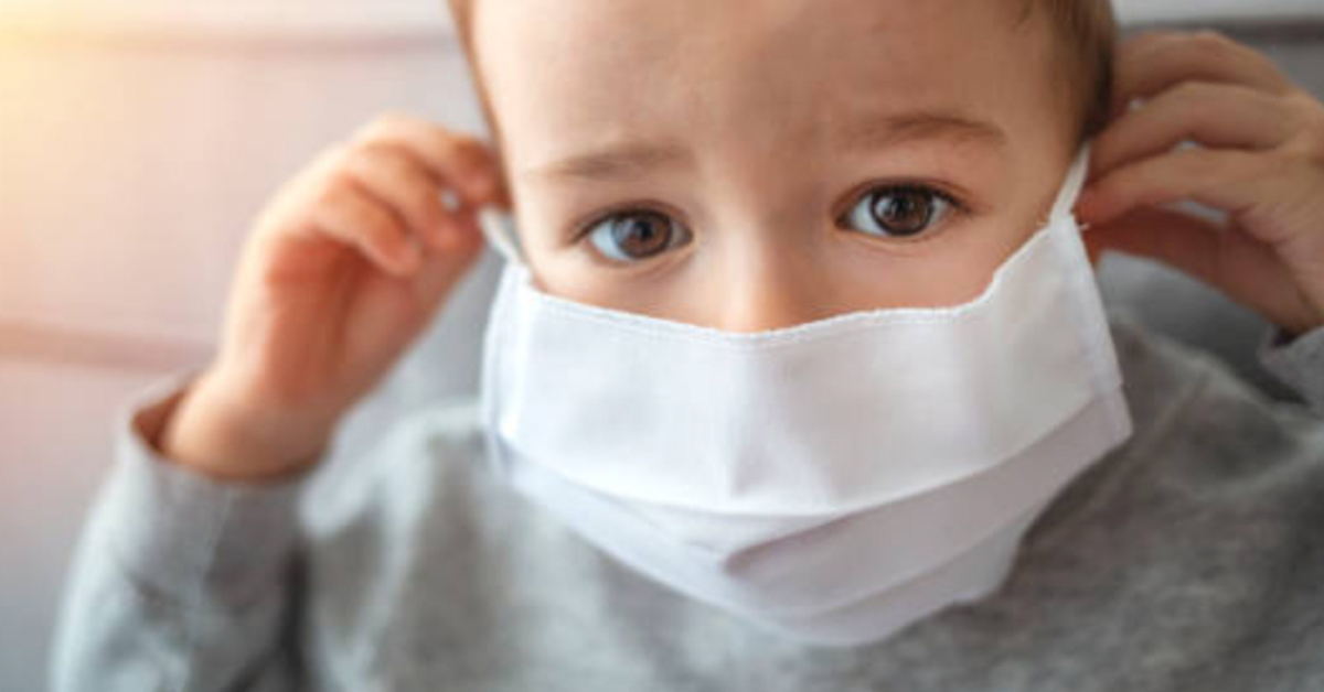 A child wearing a medical mask.