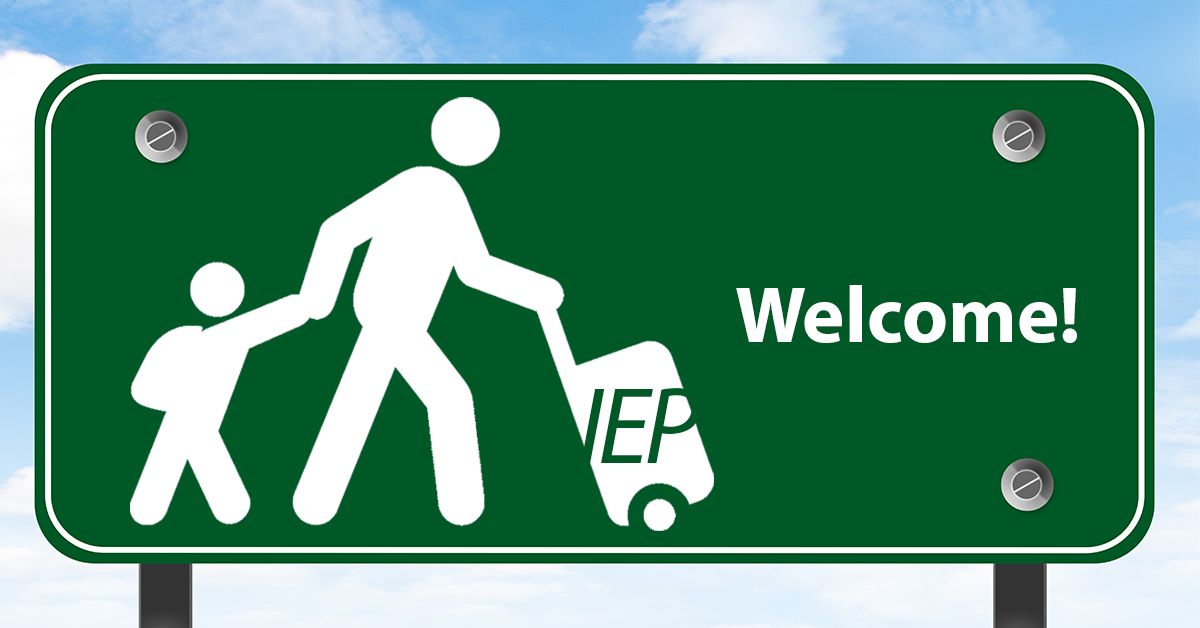 A green welcome sign with a man and a child.