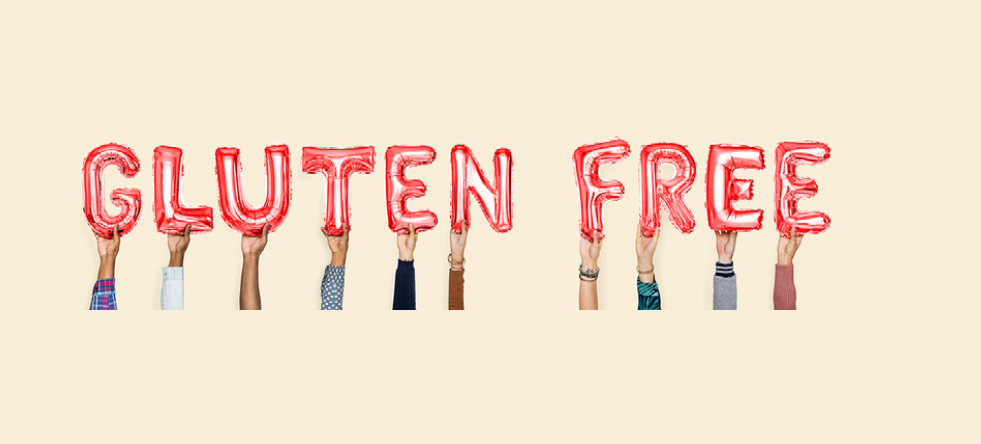 A group of people holding up the word gluten free.