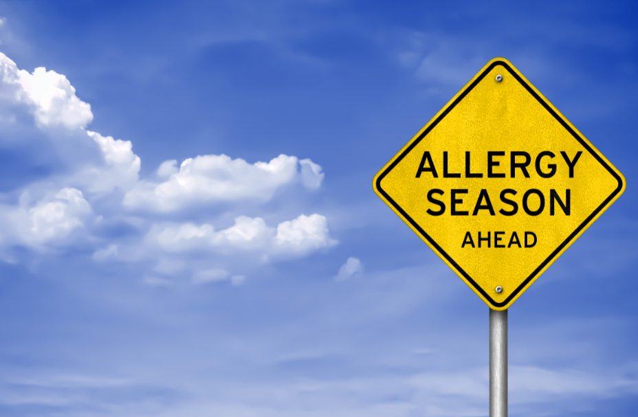 Allergy season ahead sign against a blue sky.